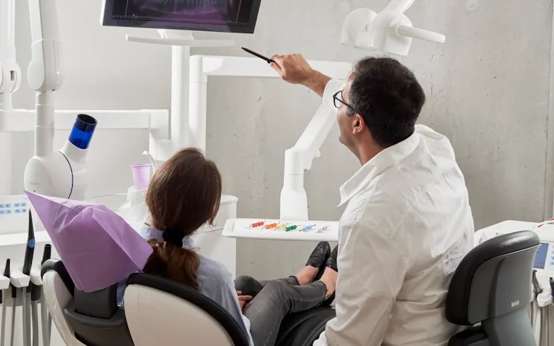 Dental professional examining a tooth for sensitivity and enamel wear