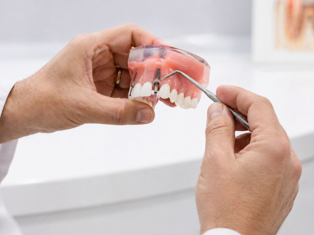 Dentist demonstrating dental implant on model