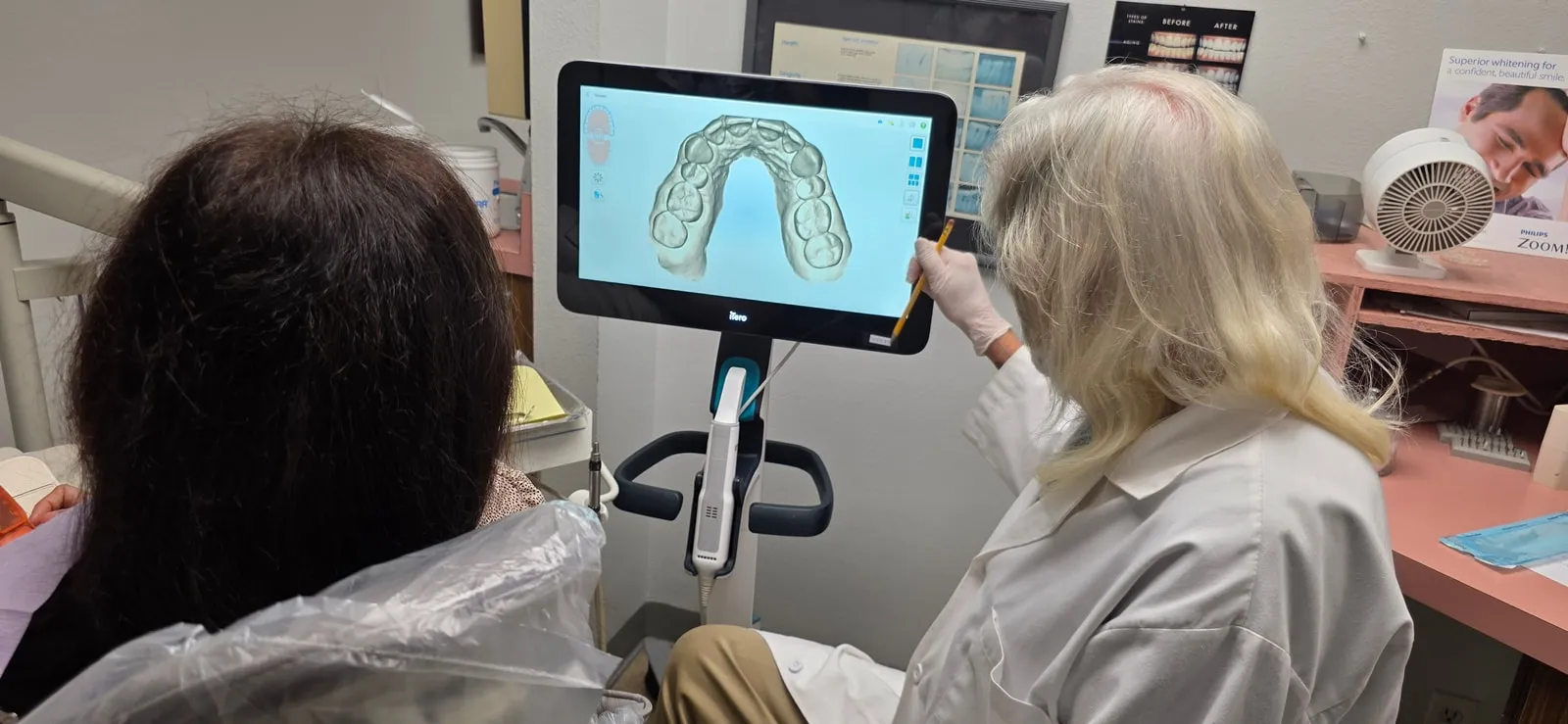 Dentist consulting with a patient using 3D dental scan technology in Huntington Beach