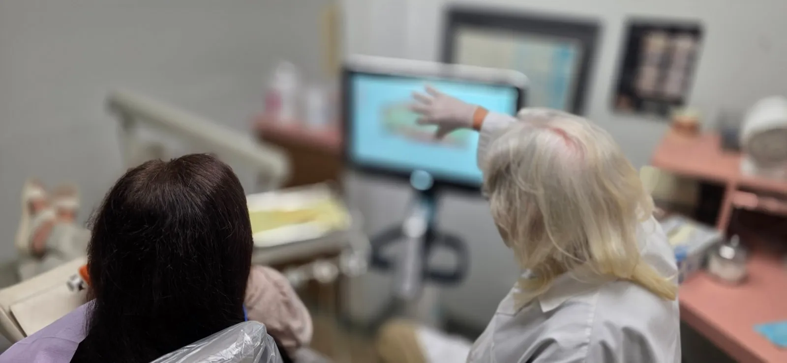 Huntington Beach dental team reviewing digital X-ray images with a patient