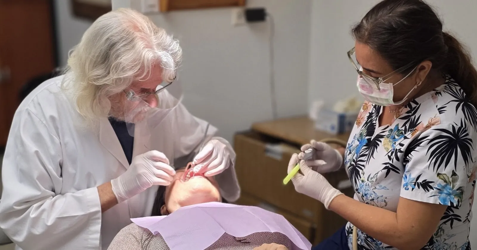 Dr. Richard Baldwin and dental assistant providing patient treatment in Huntington Beach