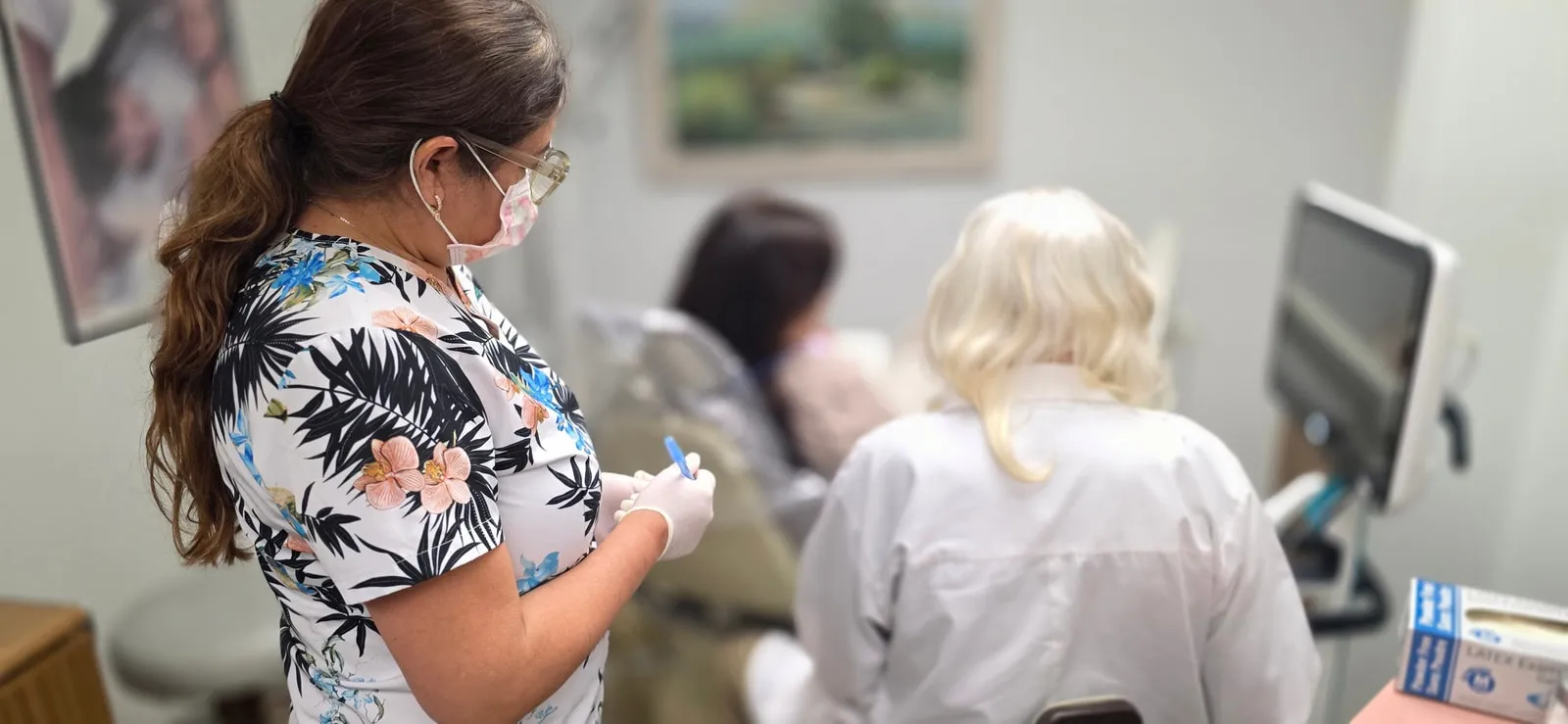 Dr. Richard Baldwin and dental assistant planning patient treatment in Huntington Beach